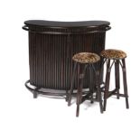 Bar: An ebonised wood Tiki bar, together with two stools, 130cm wide. The history of the Tiki Bar