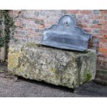 Trough/planter: A carved stone trough, 48cm high by 118cm long by 80cm deep surmounted by a lead