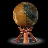 Interior design/minerals: A jasper sphere, Madagascar, on wooden stand, 21cm diameter