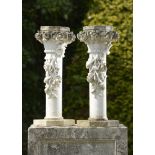 Pedestal/Interior Design: A pair of unusual carved white marble pedestals with rose basket tops,