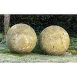 Finials: A pair of large composition stone balls, 53cm diameter