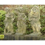 Garden Statuary:A set of three composition stone putti representing Spring, Autumn and Winter 84cm