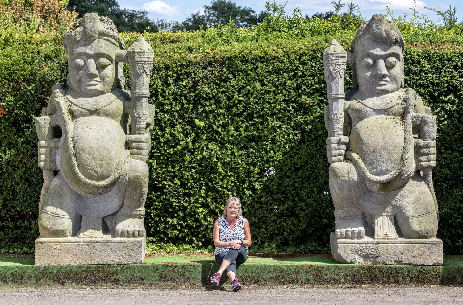 Garden statues: A pair of monumental and impressive carved stone temple guardians (Dvarapala),