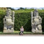 Garden statues: A pair of monumental and impressive carved stone temple guardians (Dvarapala),