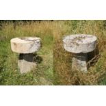 Garden Tables/Furniture: A pair of carved stone tables with millstone tops on staddlestone bases,