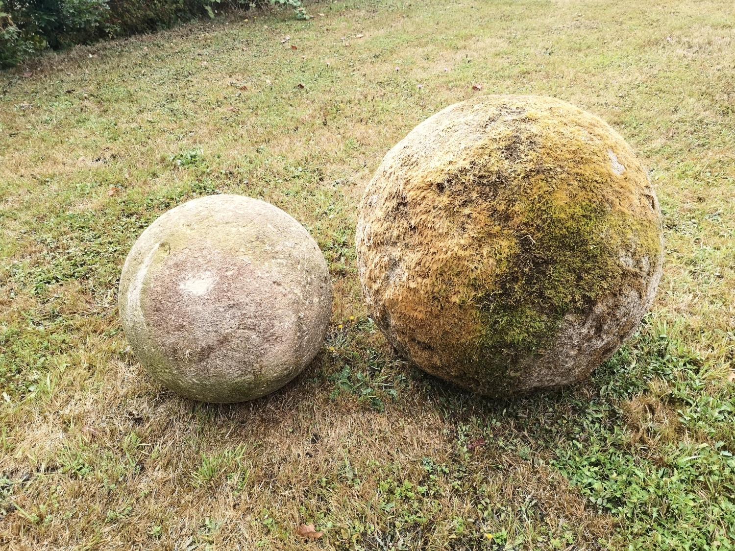 Gate piers: A substantial carved Cotswold stone ball, 52cm diameter, together with a smaller