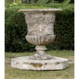 Garden pots/planters: A substantial carved Cotswold stone urn, 18th century, on associated octagonal