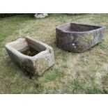 Troughs/Planters: A carved sandstone D-shaped trough, 27cm high by 67cm deep, together with
