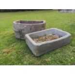 Troughs/Planters: A carved sandstone D-shaped trough, 35cm high by 68cm deep, together with a