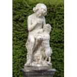 Garden statues: A white marble group of a conveniently draped boy seated on a rocky outcrop, a dog