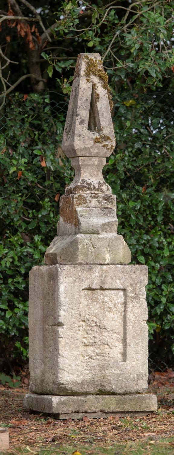 Finials: An unusual carved stone finial on associated base, mid 19th century, 220cm highThe Cotswold