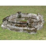 Water features: A composition stone circular pool surround, late 20th century, with scallop shell