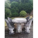 Garden seats: A suite of composition stone furniture comprising table and four chairs, the table