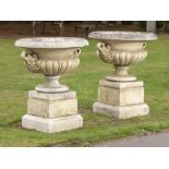 Garden pots/planters: A pair of composition stone Pulham style urns on pedestals, late 20th century,