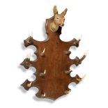 Hall Furniture: An Edwardian oak wall coat rack , early 20th century, mounted with Roe deer antlers,