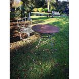 Garden seats: A wrought iron seat, French, 1st half 20th century, 123cm wide, together with a