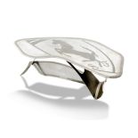 Automobilia: A polished steel Ferrari coffee table, the top etched with a Ferrari style horse and