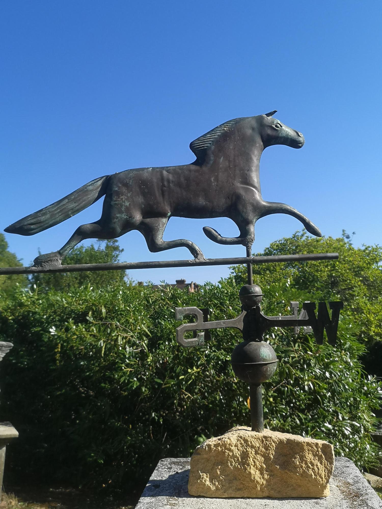Weathervanes: A copper weathervane, late 19th/early 20th century, on associated stone base, 86cm