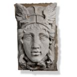 Architectural: A carved Portland stone keystone carved in high relief with a Hermes mask, circa