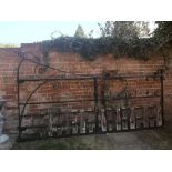 Gates: A wrought iron estate gate, early 20th century, with wooden dog guards, 166cm high by 295cm