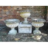 Garden pots/planters: A set of three carved stone urns, 48cm high