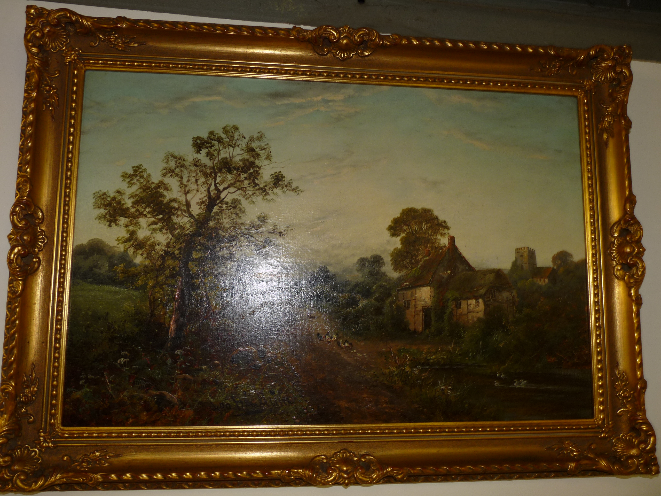 Signed and gilt framed oil on canvas of a countryside scene