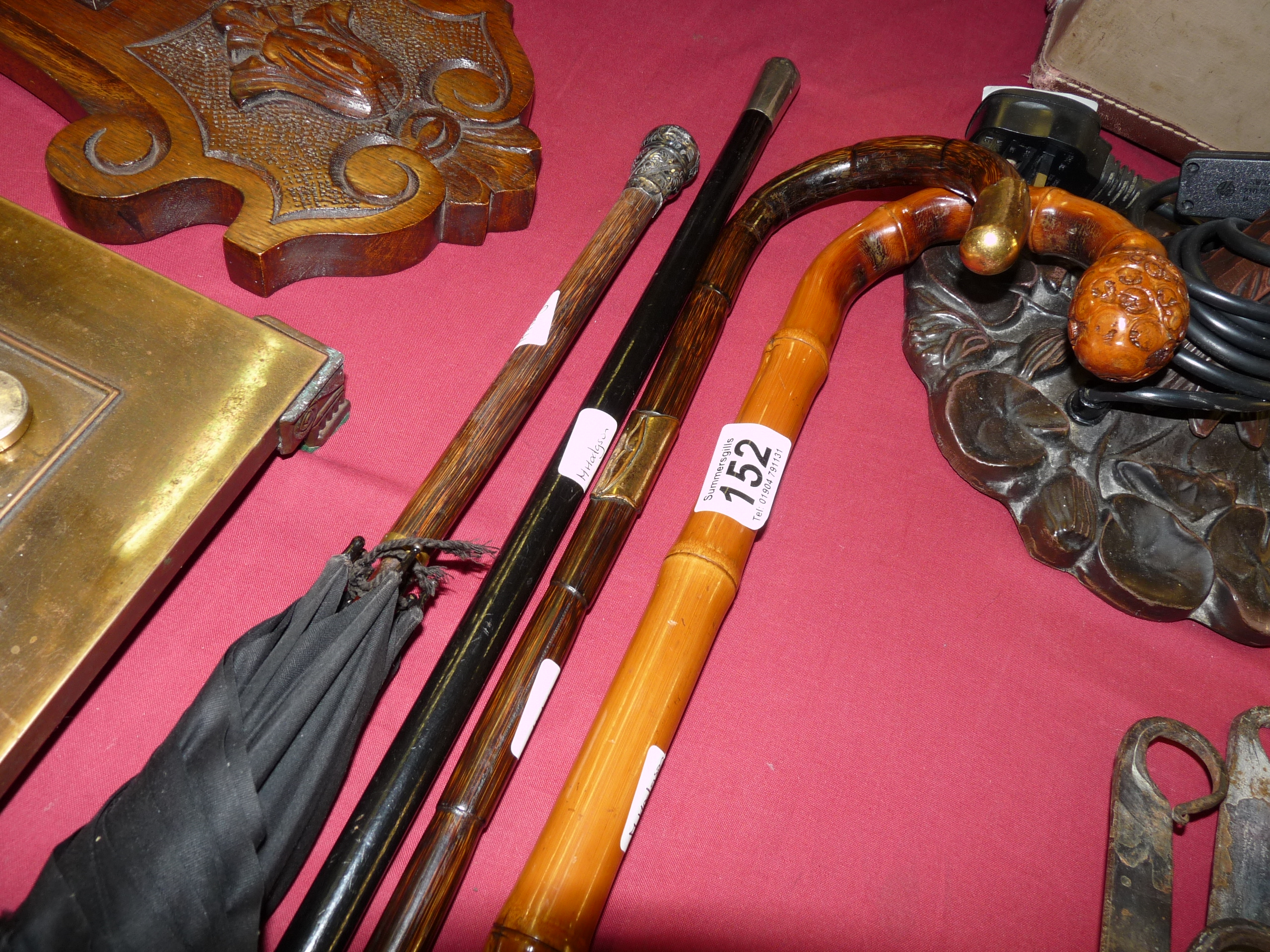 Silver-topped umbrella, brass-handled walking stick and 2 others
