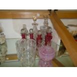 Group of Cranberry and standard glass decanters and jars