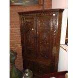 Carved antique oak corner cupboard