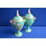 Pair of green continental pedestal urns 33cm