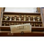Cased brass-plated pewter chess set with Alfred Dunhill Hong Kong receipt