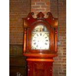 Grandfather clock with painted face and mahogany case in the farmhouse style