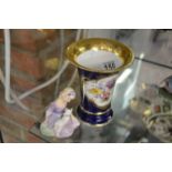 Meissen blue and floral gilt edged trumpet vase and Doulton figure