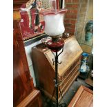 Standing Ruby glass oil lamp on metal stand
