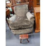 Brown upholstered armchair and milking stool