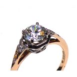 AN 18CT GOLD AND CUBIC ZIRCONIA DRESS RING Having a single round cut stone with diamond set