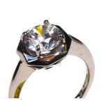AN 18CT WHITE GOLD AND CUBIC ZIRCONIA RING Having a single round cut stone in a geometric form mount