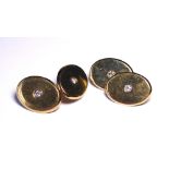 A PAIR OF 9CT GOLD CUFFLINKS Oval form set with single diamonds.