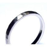 AN 18CT WHITE GOLD WEDDING BAND Plain form with planished finish (size N).