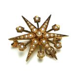 A VICTORIAN 15CT GOLD AND SEED PEARL STAR BROOCH Having an arrangement of graduated pearls. (