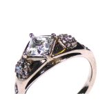 AN 18CT WHITE GOLD AND CUBIC ZIRCONIA RING Having a princess cut stone (size M).