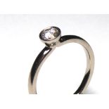 AN 18CT GOLD AND DIAMOND SOLITAIRE RING Having a single volley set round cut diamond (size L). (