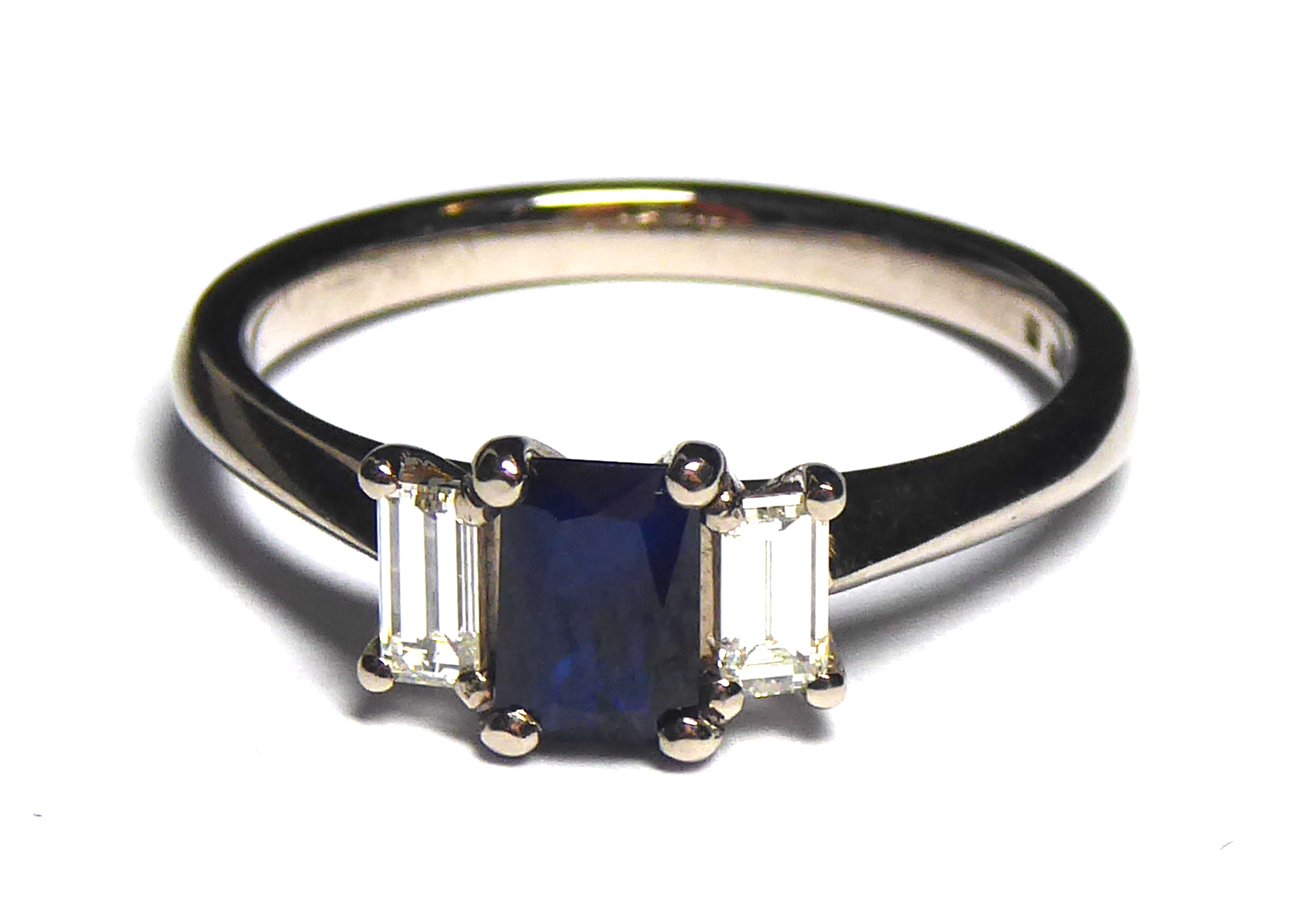 AN 18CT GOLD, SAPPHIRE AND DIAMOND THREE STONE RING Having an emerald cut sapphire flanked by - Image 2 of 2