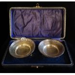 A CASED PAIR OF EARLY 20TH CENTURY SILVER BON BON DISHES Spherical form with pierced decoration on