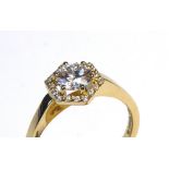 AN 18CT GOLD AND ROUND BRILLIANT CUT DIAMOND HALO RING The central diamond having a diamond