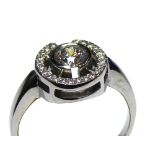 AN 18CT WHITE GOLD AND ROUND BRILLIANT CUT DIAMOND HALO RING The central diamond surrounded by a