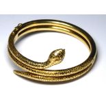 AN ART DECO 18CT GOLD AND DIAMOND SNAKE BRACELET Having diamond set eyes and textured finish, in