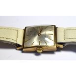 EXCALIBUR, A VINTAGE GENT'S 9CT GOLD WATCH Having a silver tone square dial with gilt number