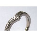 AN 18CT WHITE GOLD AND DIAMOND HALF ETERNITY RING Having two rows of diamonds forming a 'V' shape (