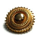 A 19TH CENTURY ETRUSCAN FORM BROOCH Circular target form with compartment to verso. (approx diameter